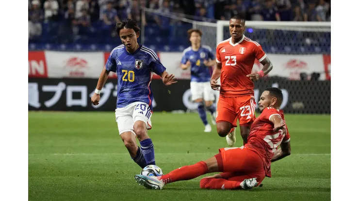 SUITA, JAPAN - JUNE 20: Takefusa Kubo of Japan is tackled by Alexander Callens of Peru during the international friendly match between Japan and Peru at Panasonic Stadium Suita on June 20, 2023 in Suita, Osaka, Japan. (Photo by Koji Watanabe/Getty Images)