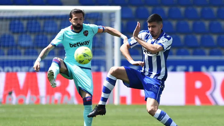 VITORIA-GASTEIZ, SPAIN - MAY 08: Roger of Levante UD battles for possession with Rodrigo Battaglia of Deportivo Alaves during the La Liga Santander match between Deportivo Alavés and Levante UD at Estadio de Mendizorroza on May 08, 2021 in Vitoria-Gasteiz, Spain. Sporting stadiums around Spain remain under strict restrictions due to the Coronavirus Pandemic as Government social distancing laws prohibit fans inside venues resulting in games being played behind closed doors. (Photo by Juan Manuel Serrano Arce/Getty Images)
