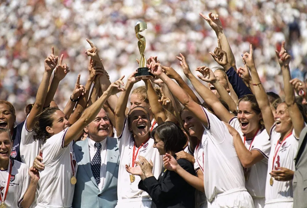 PASADENA, CALIFORNIA – JULY 10: Captian Carla Overbeck #4 of the US Women’s Soccer Team raises the World Cup Trophy, as the team celebrates their victory over Team China in the Championship match of the FIFA Women’s World Cup at the Rose Bowl on July 10, 1999 in Pasadena, California. Team USA defeated Team China 5-4 in sudden death after two overtimes. (Photo by Harry How/Getty Images)