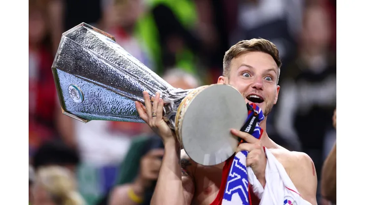 BUDAPEST, HUNGARY - MAY 31: Ivan Rakitic of Sevilla FC holds the winners trophy after the UEFA Europa League 2022/23 final match between Sevilla FC and AS Roma at Puskas Arena on May 31, 2023 in Budapest, Hungary. (Photo by Clive Rose/Getty Images)