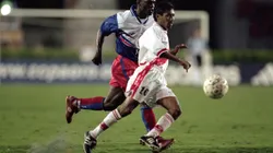 14 Feb 2000: Roberto Palacios #10 of Peru runs with the ball as Wilfred Montilas #14 of Haiti runs next to him during the Gold Cup 2000 Game at the Orange Bowl in Miami, Florida. Team Haiti tied Team Peru 1-1. Mandatory Credit: Andy Lyons /Allsport