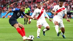 YEKATERINBURG, RUSSIA - JUNE 21: Kylian Mbappe of France crosses the ball under pressure from Miguel Trauco of Peru and Anderson Santamaria of Peru during the 2018 FIFA World Cup Russia group C match between France and Peru at Ekaterinburg Arena on June 21, 2018 in Yekaterinburg, Russia. (Photo by Kevin C. Cox/Getty Images)