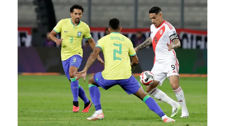 LIMA, PERU - SEPTEMBER 12: Paolo Guerrero of Peru competes for the ball with Danilo of Brazil during a FIFA World Cup 2026 Qualifier match between Peru and Brazil at Estadio Nacional de Lima on September 12, 2023 in Lima, Peru. (Photo by Mariana Bazo/Getty Images)
