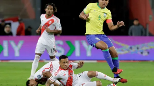 LIMA, PERU - SEPTEMBER 12: Casemiro of Brazil competes for the ball with Yoshimar Yotun of Peru during a FIFA World Cup 2026 Qualifier match between Peru and Brazil at Estadio Nacional de Lima on September 12, 2023 in Lima, Peru. (Photo by Mariana Bazo/Getty Images)