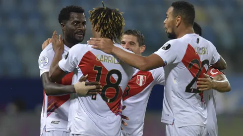 GOIANIA, BRAZIL - JUNE 20: Christian Ramos, André Carrillo and Alexander Callens of Peru celebrate with teammates after their second goal scored by an own goal of Yerry Mina of Colombia (not in frame) during a group B match between Colombia and Peru as part of Copa America Brazil 2021 at Estadio Olimpico on June 20, 2021 in Goiania, Brazil. (Photo by Pedro Vilela/Getty Images)
