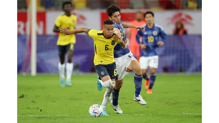 DUESSELDORF, GERMANY - SEPTEMBER 27: Byron Castillo of Ecuador battles for possession with Ao Tanaka of Japan during the international friendly match between Japan and Ecuador at Merkur Spiel-Arena on September 27, 2022 in Duesseldorf, Germany. (Photo by Alex Grimm/Getty Images)