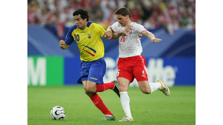 GELSENKIRCHEN, GERMANY - JUNE 09: Arkadiusz Radomski of Poland and Ivan Kaviedes of Ecuador battle for the ball during the FIFA World Cup Germany 2006 Group A match between Poland and Ecuador at the Stadium Gelsenkirchen on June 9, 2006 in Gelsenkirchen, Germany. (Photo by Laurence Griffiths/Getty Images)
