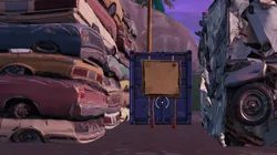 Busca la señal del mapa del tesoro que hay en Chiringuito Chatarra - Desafíos Semanales de Fortnite