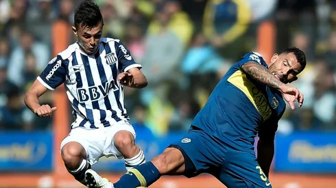 TRABA Y GANA. Andrés Cuba pelea contra Carlos Tevez en La Bombonera (Foto: Getty).