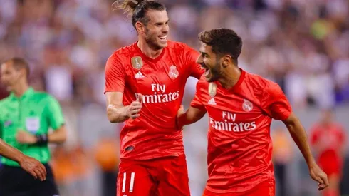 FESTEJO DE ROJOS. Bale y Asensio celebran el 1-0 de Real Madrid contra Roma.