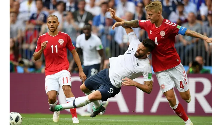 Giroud disputa una pelota ante un rival de Dinamarca