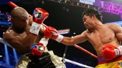 Manny Pacquiao lanza un derechazo a Floyd Mayweather Jr. durante su combate por la unificación del peso welter.