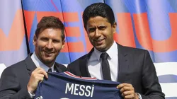 PARIS, FRANCE - AUGUST 11: Lionel Messi poses with his jersey next to President Nasser Al Khelaifi after the press conference of Paris Saint-Germain at Parc des Princes on August 11, 2021 in Paris, France. (Photo by Sebastien Muylaert/Getty Images)