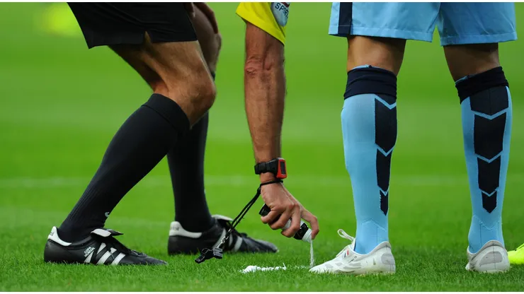 NEWCASTLE UPON TYNE, ENGLAND - AUGUST 17: Referee Martin Atkinson sprays his magic free kick line spray during the Barclays Premier League match between Newcastle United and Manchester City at St James' Park on August 17, 2014 in Newcastle upon Tyne, England. (Photo by Stu Forster/Getty Images)