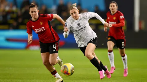 MANCHESTER, ENGLAND - JANUARY 24: Laura Coombs of Manchester City runs with the ball whilst under pressure from Maya Le Tissier of Manchester United during the FA Women's Continental Tyres League Cup match between Manchester City and Manchester United at Joie Stadium on January 24, 2024 in Manchester, England. (Photo by Gareth Copley/Getty Images)