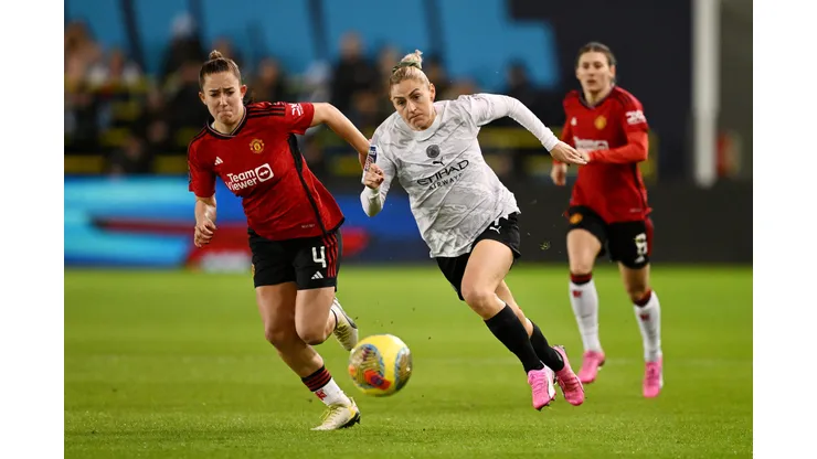 MANCHESTER, ENGLAND - JANUARY 24: Laura Coombs of Manchester City runs with the ball whilst under pressure from Maya Le Tissier of Manchester United during the FA Women's Continental Tyres League Cup match between Manchester City and Manchester United at Joie Stadium on January 24, 2024 in Manchester, England. (Photo by Gareth Copley/Getty Images)