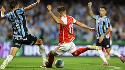 CURITIBA, BRAZIL - JUNE 22: Lucas Alario of Internacional tries to shoot past Pedro Geromel (L) of Gremio during the match between Gremio and Internacional as part of Brasileirao 2024 at Couto Pereira Stadium on June 22, 2024 in Curitiba, Brazil. (Photo by Heuler Andrey/Getty Images)