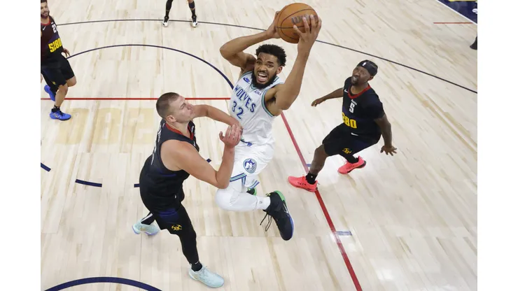 Karl-Anthony Towns, dos Wolves, tenta enterrada em cima de Nikola Jokic (Foto: C. Morgan Engel/Getty Images)