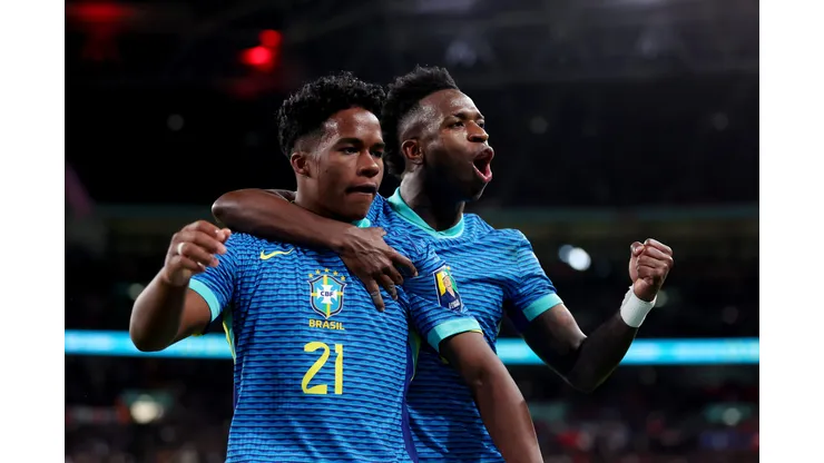 LONDON, ENGLAND - MARCH 23: Endrick of Brazil celebrates scoring his team's first goal with teammate Vinicius Junior during the international friendly match between England and Brazil at Wembley Stadium on March 23, 2024 in London, England. (Photo by Catherine Ivill/Getty Images)