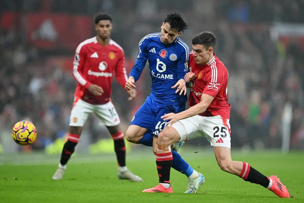 MANCHESTER, ENGLAND – NOVEMBER 10: Facundo Buonanotte of Leicester City is challenged by Manuel Ugarte of Manchester United during the Premier League match between Manchester United FC and Leicester City FC at Old Trafford on November 10, 2024 in Manchester, England. (Photo by Michael Regan/Getty Images)