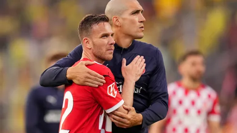 GIRONA, SPAIN - MAY 10: Arthur Melo and Oriol Romeu of Girona FC embrace following the team's defeat during the LaLiga match between Girona FC and Villarreal CF at Montilivi Stadium on May 10, 2025 in Girona, Spain. (Photo by Alex Caparros/Getty Images)