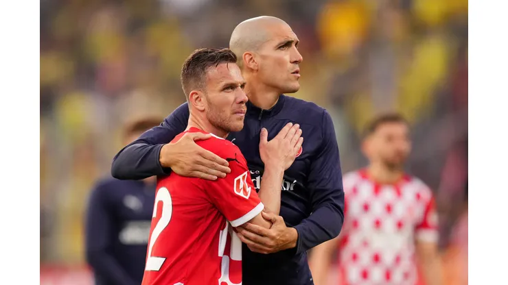 GIRONA, SPAIN - MAY 10: Arthur Melo and Oriol Romeu of Girona FC embrace following the team's defeat during the LaLiga match between Girona FC and Villarreal CF at Montilivi Stadium on May 10, 2025 in Girona, Spain. (Photo by Alex Caparros/Getty Images)