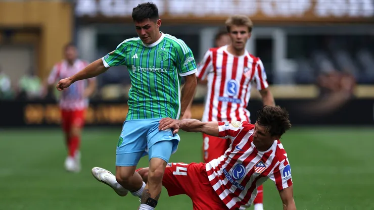 SEATTLE, WASHINGTON - JUNE 19: Kalani Kossa-Rienzi #85 of Seattle Sounders FC is challenged by Robin Le Normand #24 of Atletico De Madrid during the FIFA Club World Cup 2025 group B match between Seattle Sounders FC and Club Atletico de Madrid at Lumen Field on June 19, 2025 in Seattle, Washington. (Photo by Buda Mendes/Getty Images)