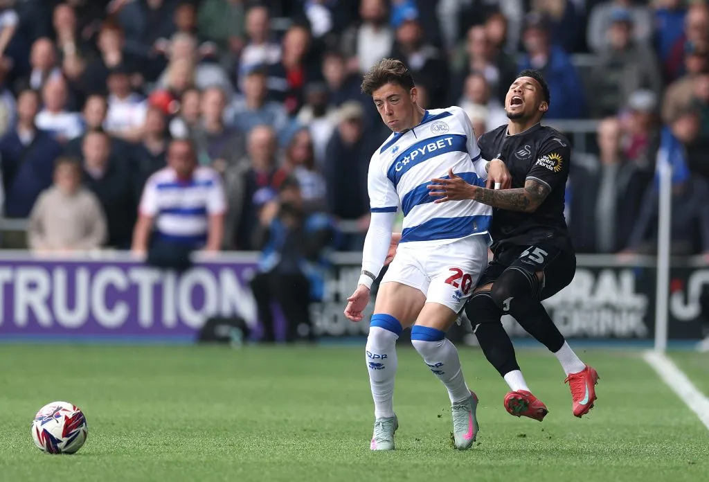 LONDON, ENGLAND – APRIL 21: Reggie Cannon of Queens Park Rangers fouls Ronald of Swansea City during the Sky Bet Championship match between Queens Park Rangers FC and Swansea City AFC at Loftus Road on April 21, 2025 in London, England. (Photo by Warren Little/Getty Images)
