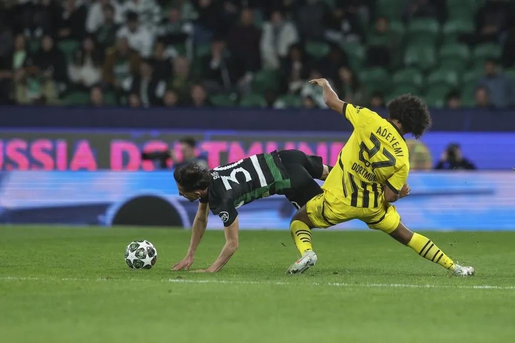 LISBON, PORTUGAL – FEBRUARY 12: Karim Adeyemi of Borussia of Dortmund  (R) tackles Biel Teixeira of Sporting CP (L) during the UEFA Champions League 2024/25 League Knockout Play-off First Leg match between Sporting Clube de Portugal and Borussia Dortmund at  on February 12, 2025 in Lisbon, Portugal. (Photo by Carlos Rodrigues/Getty Images)