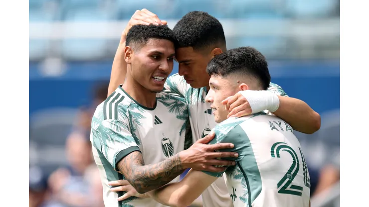 KANSAS CITY, KANSAS - APRIL 13: Kevin Kelsy #19 of Portland Timbers is congratulated by Antony #11 and David Ayala #24 after scoring during the match against Sporting Kansas City at Children's Mercy Park on April 13, 2025 in Kansas City, Kansas. (Photo by Jamie Squire/Getty Images)