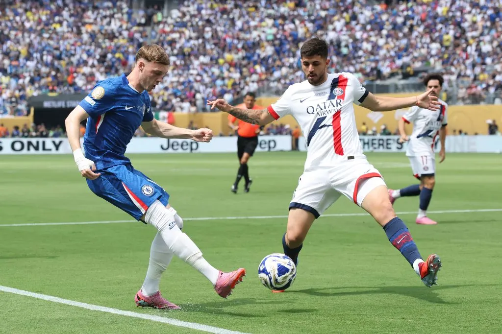 EAST RUTHERFORD, NEW JERSEY – JULY 13: Cole Palmer #10 of Chelsea FC is challenged by Lucas Beraldo #4 of Paris Saint-Germain during the FIFA Club World Cup 2025 Final match between Chelsea FC and Paris Saint-Germain at MetLife Stadium on July 13, 2025 in East Rutherford, New Jersey. (Photo by Alex Grimm/Getty Images)