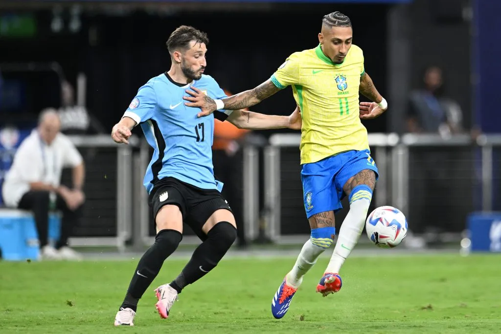 LAS VEGAS, NEVADA – JULY 06: Raphinha of Brazil controls the ball against Matias Viña of Uruguay during the CONMEBOL Copa America 2024 quarterfinal match between Uruguay and Brazil at Allegiant Stadium on July 06, 2024 in Las Vegas, Nevada. (Photo by Candice Ward/Getty Images)