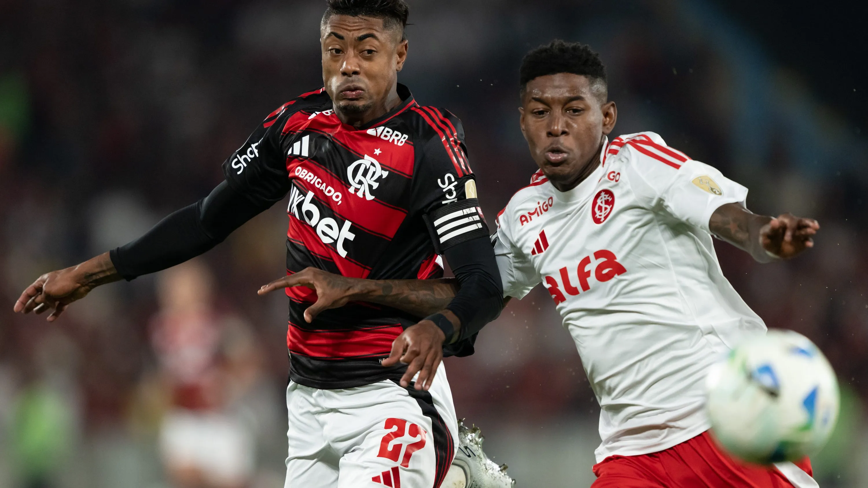 Bruno Henrique, jogador do Flamengo, disputa lance com Vitao jogador do Internacional durante partida no estadio Maracana pelo campeonato Copa Libertadores 2025. Foto: Jorge Rodrigues/AGIF