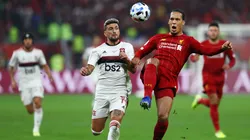 DOHA, QATAR - DECEMBER 21: Virgil van Dijk of Liverpool controls the ball as he is put under pressure by Giorgian De Arrascaeta of CR Flamengo during the FIFA Club World Cup Qatar 2019 Final between Liverpool FC and CR Flamengo at Education City Stadium on December 21, 2019 in Doha, Qatar. (Photo by Francois Nel/Getty Images)