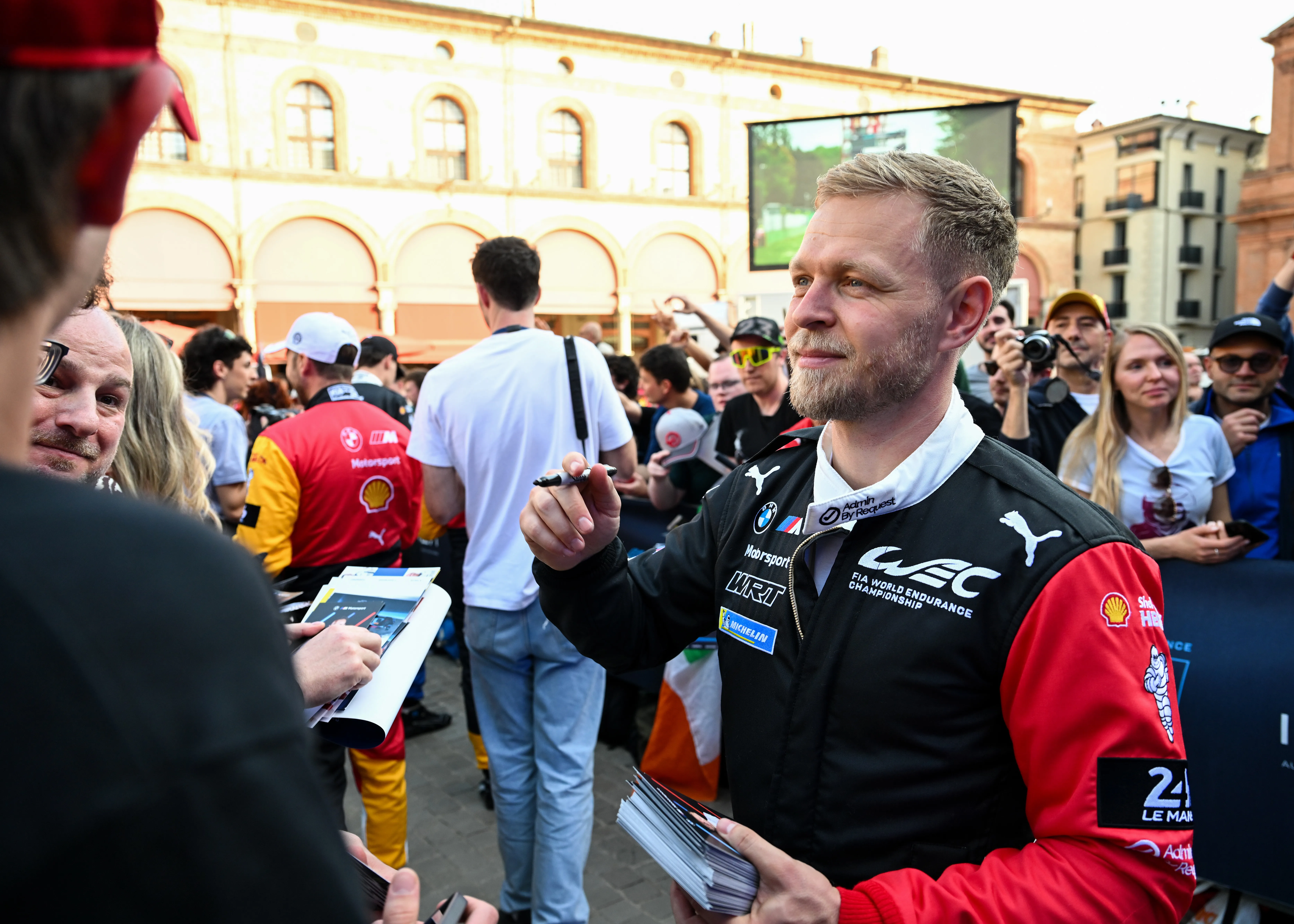 IMOLA, ITALY – APRIL 16: Kevin Magnussen of Denmark and BMW M Team WRT signs autographs for fans in Piazza Matteotti before the World Endurance Championship 6 Hours of Imola at Autodromo Enzo e Dino Ferrari on April 16, 2026 in Imola, Italy. (Photo by Sam Bagnall/Getty Images)