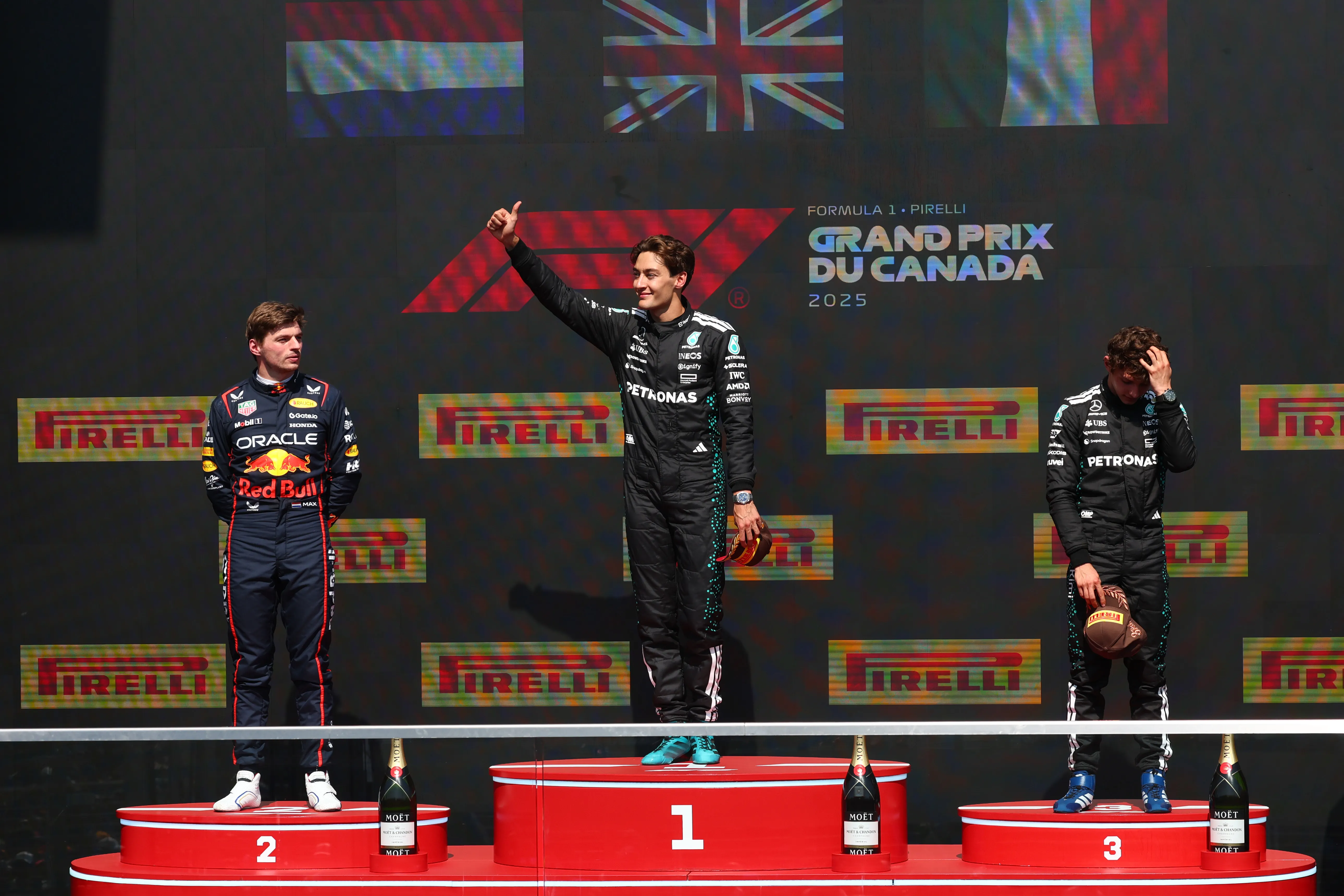 MONTREAL, QUEBEC – JUNE 15: Race winner George Russell of Great Britain and Mercedes AMG Petronas F1 Team, Second placed Max Verstappen of the Netherlands and Oracle Red Bull Racing and Third placed Andrea Kimi Antonelli of Italy and Mercedes AMG Petronas F1 Team stand on the podium during the F1 Grand Prix of Canada at Circuit Gilles-Villeneuve on June 15, 2025 in Montreal, Quebec. (Photo by Clive Rose/Getty Images)