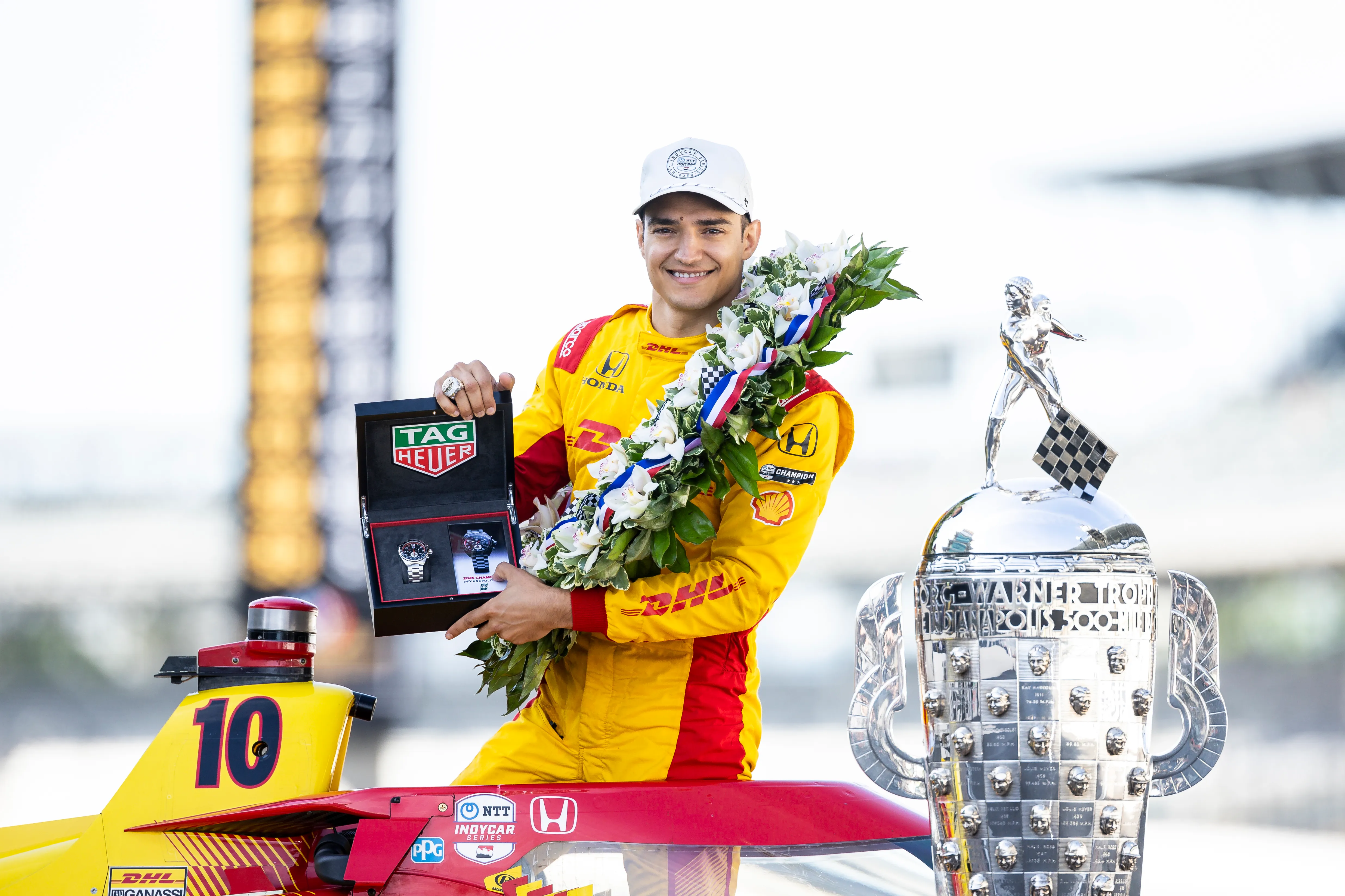 INDIANAPOLIS, INDIANA – MAY 26: Alex Palou, driver of the #10 DHL Chip Ganassi Racing Honda, poses for a photo with the Tag Heuer winner’s watch during the winner’s photo shoot for the NTT IndyCar Series 109th Running Of The Indianapolis 500 at Indianapolis Motor Speedway on May 26, 2025 in Indianapolis, Indiana. (Photo by James Gilbert/Getty Images)