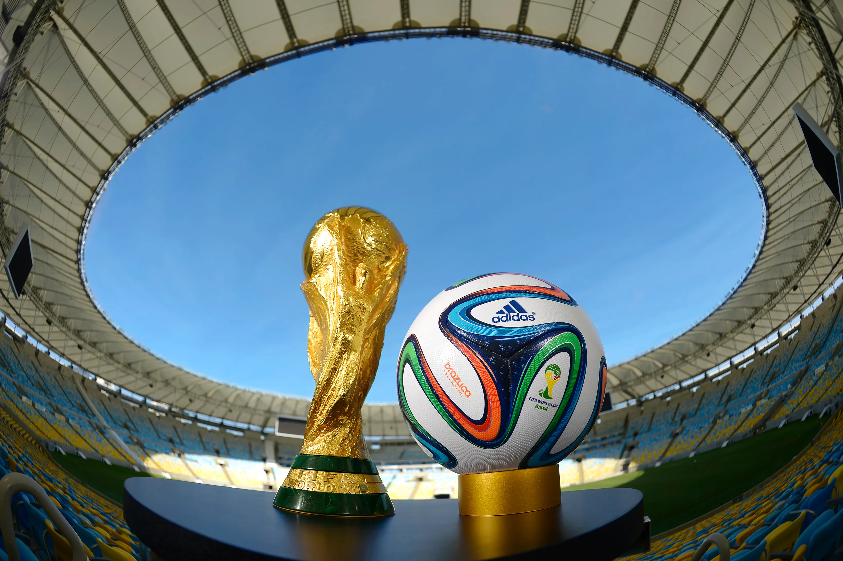 RIO DE JANEIRO, BRAZIL – DECEMBER 03:  A general view of Brazuca and the FIFA World Cup Trophy at the Maracana. (Photo by Alexandre Loureiro/Getty Images for adidas)
