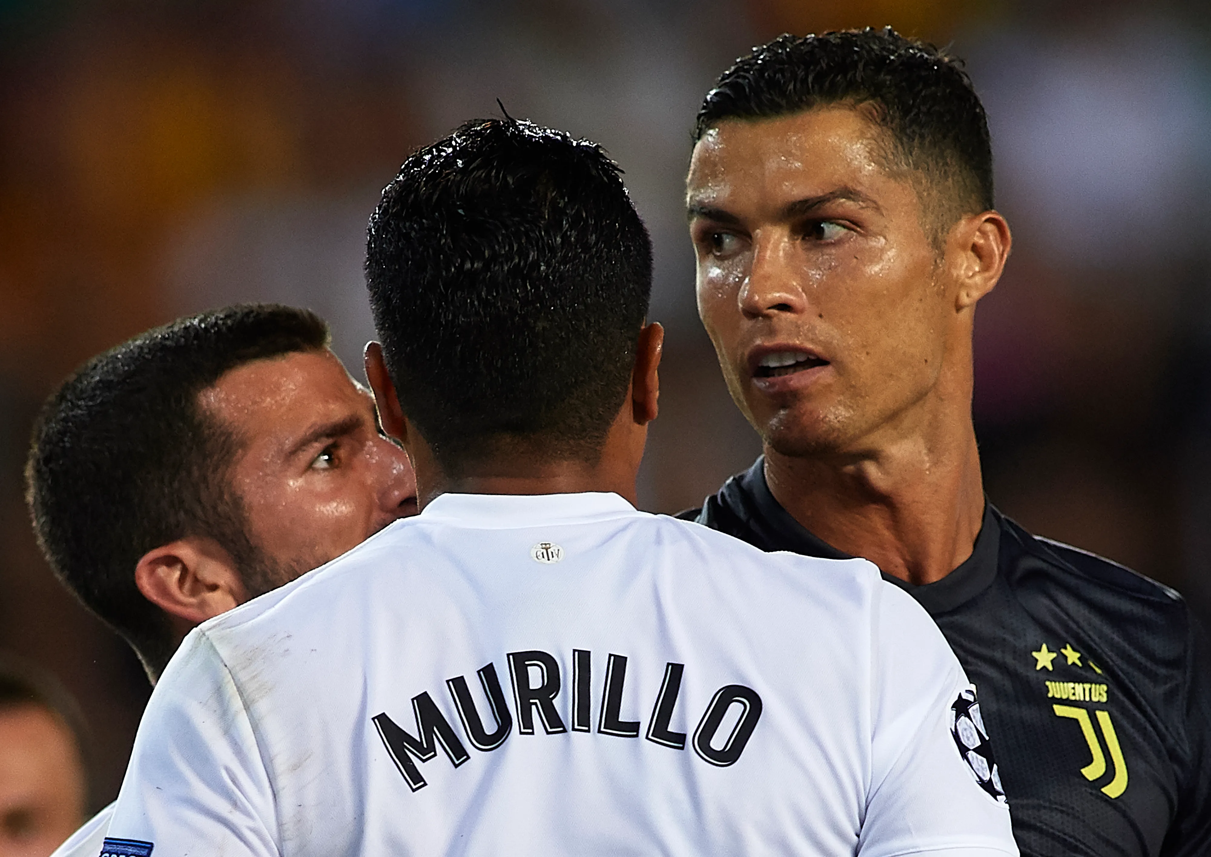 VALENCIA, SPAIN – SEPTEMBER 19:  Jose Luis Gaya and Jeison Murillo of Valencia argue to Cristano Ronaldo of Juventus during the Group H match of the UEFA Champions League between Valencia and Juventus at Estadio Mestalla on September 19, 2018 in Valencia, Spain.  (Photo by Manuel Queimadelos Alonso/Getty Images)