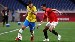 SAITAMA, JAPAN - JULY 31: Bruno Guimaraes #8 of Team Brazil battles for possession with Taher Mohamed #9 of Team Egypt during the Men's Quarter Final between Brazil and Egypt on day eight of the Tokyo Olympic Games at Saitama Stadium on July 31, 2021 in Saitama, Japan. (Photo by Buda Mendes/Getty Images)