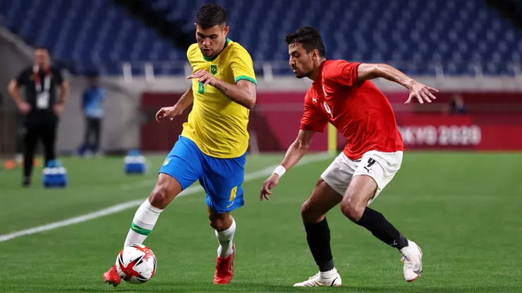 SAITAMA, JAPAN - JULY 31: Bruno Guimaraes #8 of Team Brazil battles for possession with Taher Mohamed #9 of Team Egypt during the Men's Quarter Final between Brazil and Egypt on day eight of the Tokyo Olympic Games at Saitama Stadium on July 31, 2021 in Saitama, Japan. (Photo by Buda Mendes/Getty Images)