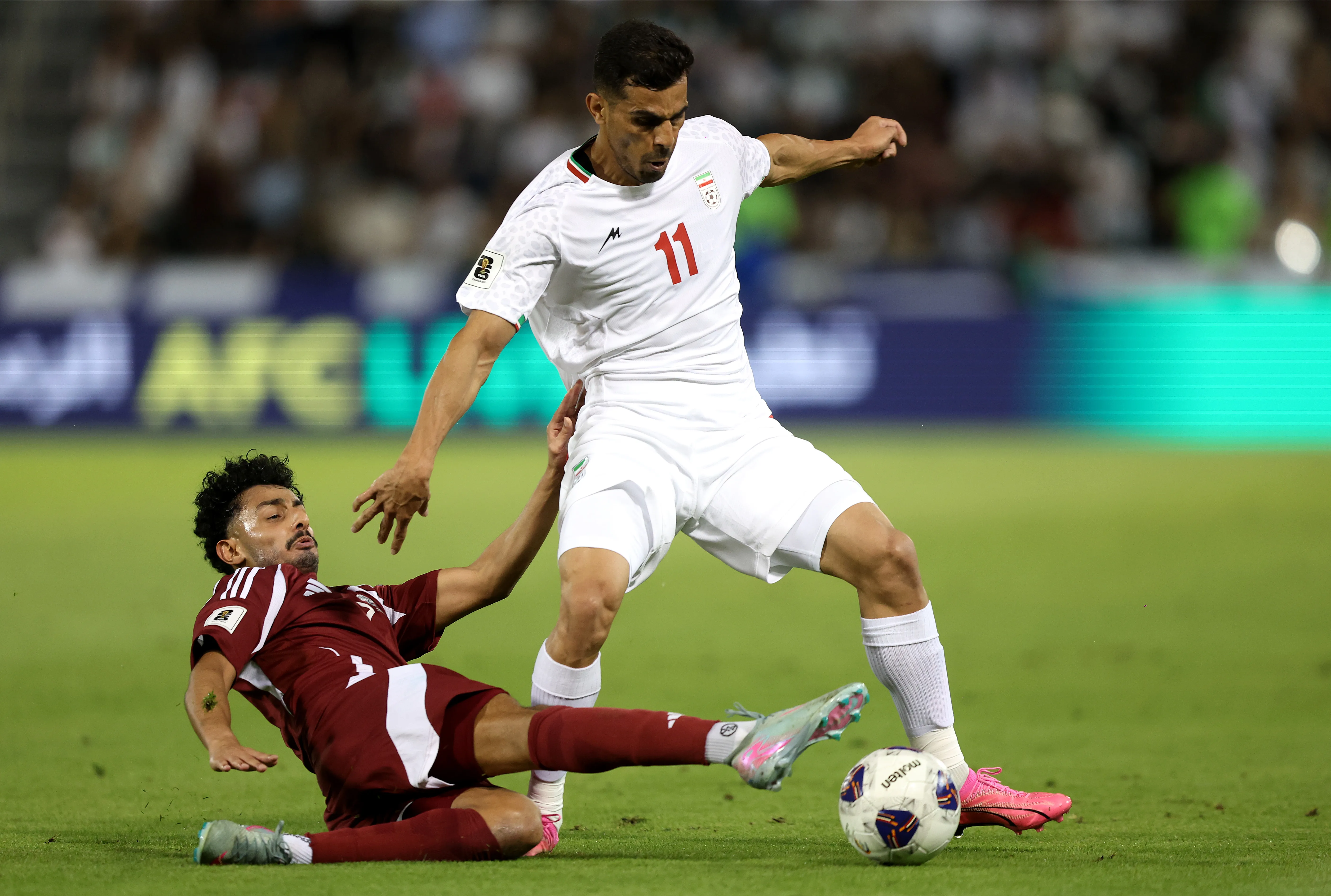 DOHA, QATAR – JUNE 05: Ali Nemati of Iran is challenged by Ahmed Al Ganehi of Qatar during the FIFA World Cup 2026 Qualifier match between Qatar and IR Iran at Jassim Bin Hamad Stadium on June 05, 2025 in Doha, Qatar.  (Photo by Mohamed Farag/Getty Images)
