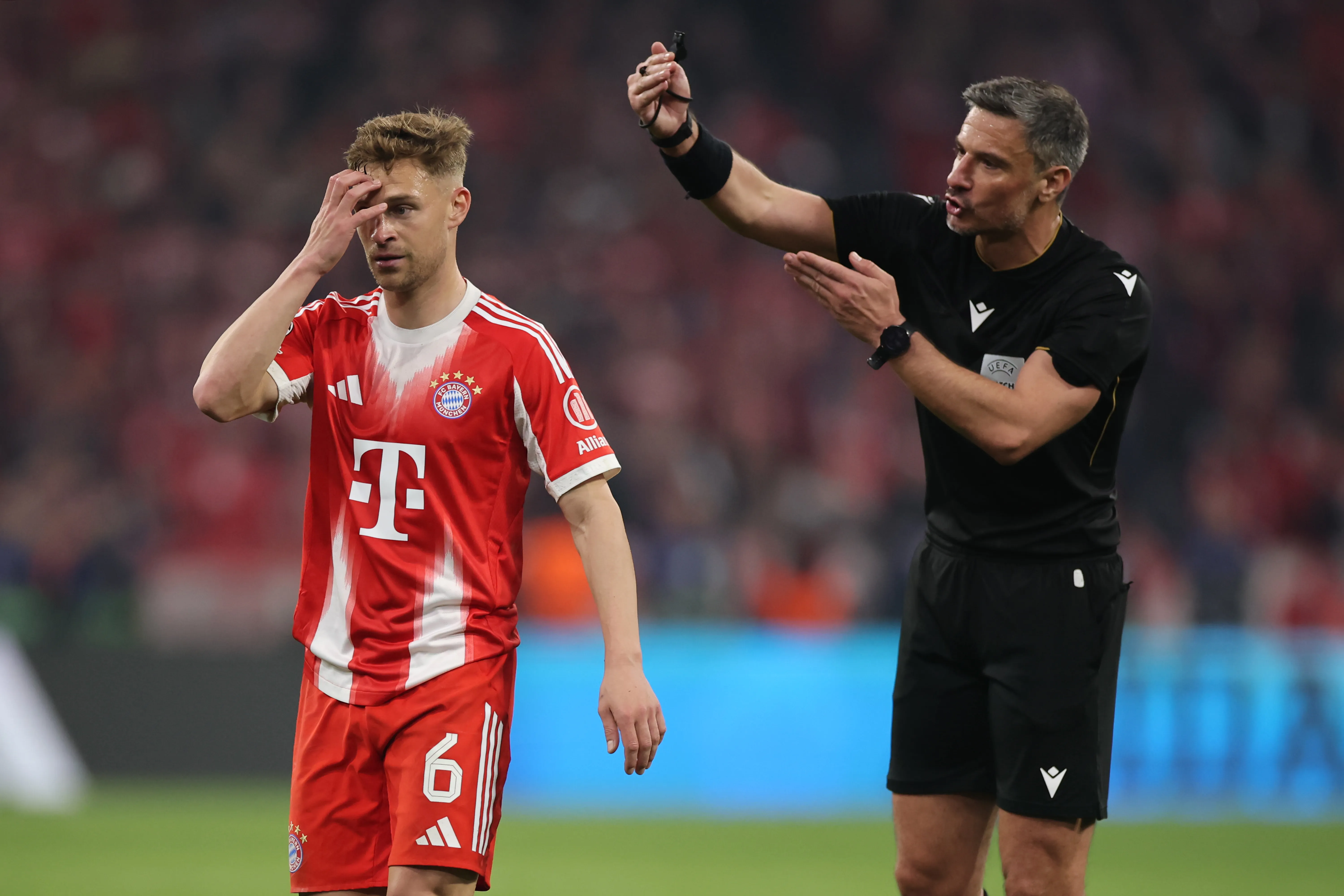 MUNICH, GERMANY – APRIL 15: Referee Slavko Vincic interactzs with Joshua Kimmich of FC Bayern Munich during the UEFA Champions League 2025/26 Quarter-Final Second Leg match between FC Bayern München and Real Madrid CF at Football Arena Munich on April 15, 2026 in Munich, Germany. (Photo by Alex Grimm/Getty Images)