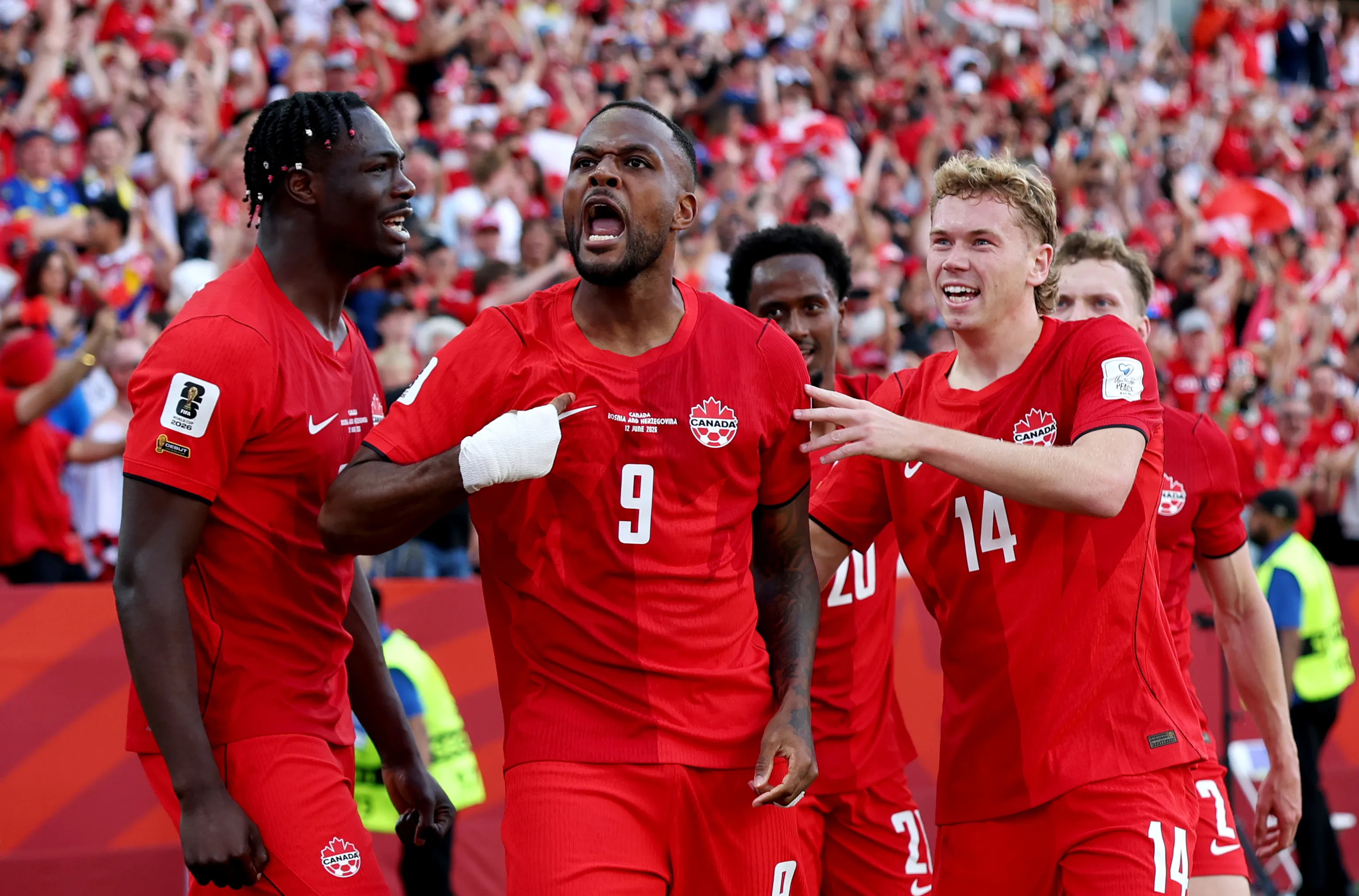 TORONTO, ONTARIO – JUNE 12: Cyle Larin #9 of Canada celebrates with teammates after scoring the team’s first goal during the FIFA World Cup 2026 Group B match between Canada and Bosnia and Herzegovina at Toronto Stadium on June 12, 2026 in Toronto, Ontario. (Photo by Charlotte Wilson/Getty Images)