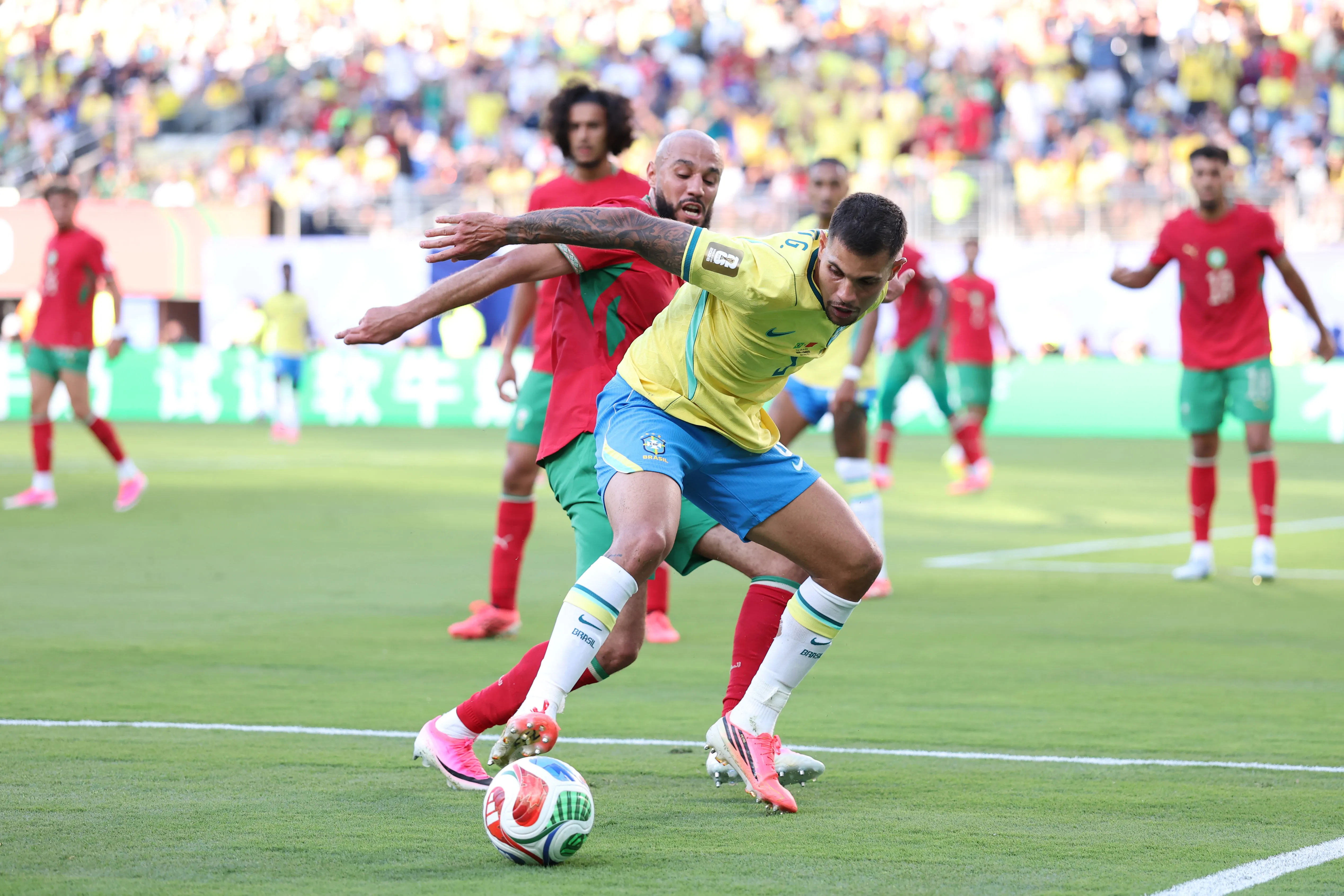 EAST RUTHERFORD, NEW JERSEY – JUNE 13: Bruno Guimaraes #8 of Brazil  is challenged by Noussair Mazraoui #3 of Morocco during the FIFA World Cup 2026 Group C match between Brazil and Morocco at New York New Jersey Stadium on June 13, 2026 in East Rutherford, New Jersey. (Photo by Kevin C. Cox/Getty Images)