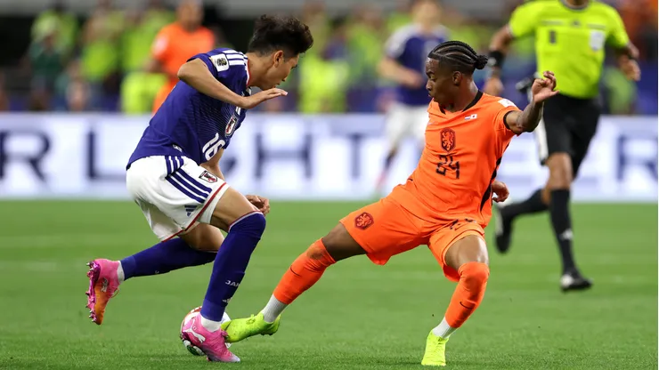 ARLINGTON, TEXAS - JUNE 14: Crysencio Summerville #24 of Netherlands controls the ball under pressure from Tsuyoshi Watanabe #16 of Japan during the FIFA World Cup 2026 Group F match between Netherlands and Japan at Dallas Stadium on June 14, 2026 in Arlington, Texas. (Photo by Francois Nel/Getty Images)