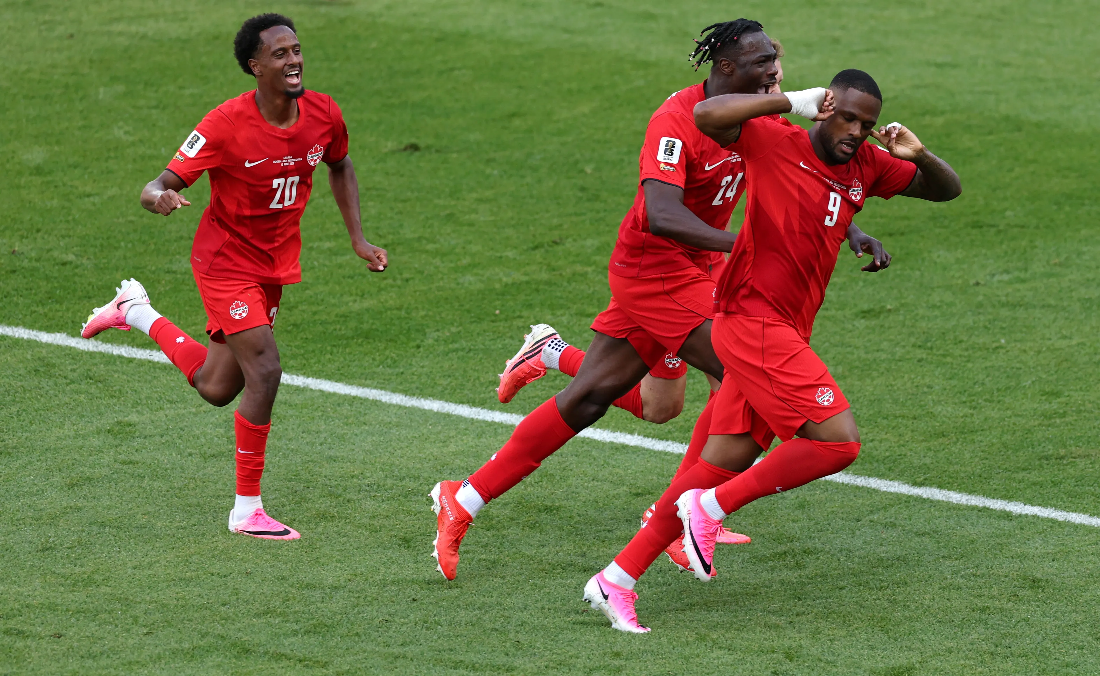TORONTO, ONTARIO – JUNE 12: Cyle Larin #9 of Canada celebrates with Promise David #24 after scoring the team’s first goal during the FIFA World Cup 2026 Group B match between Canada and Bosnia and Herzegovina at Toronto Stadium on June 12, 2026 in Toronto, Ontario. (Photo by Michael Steele/Getty Images)