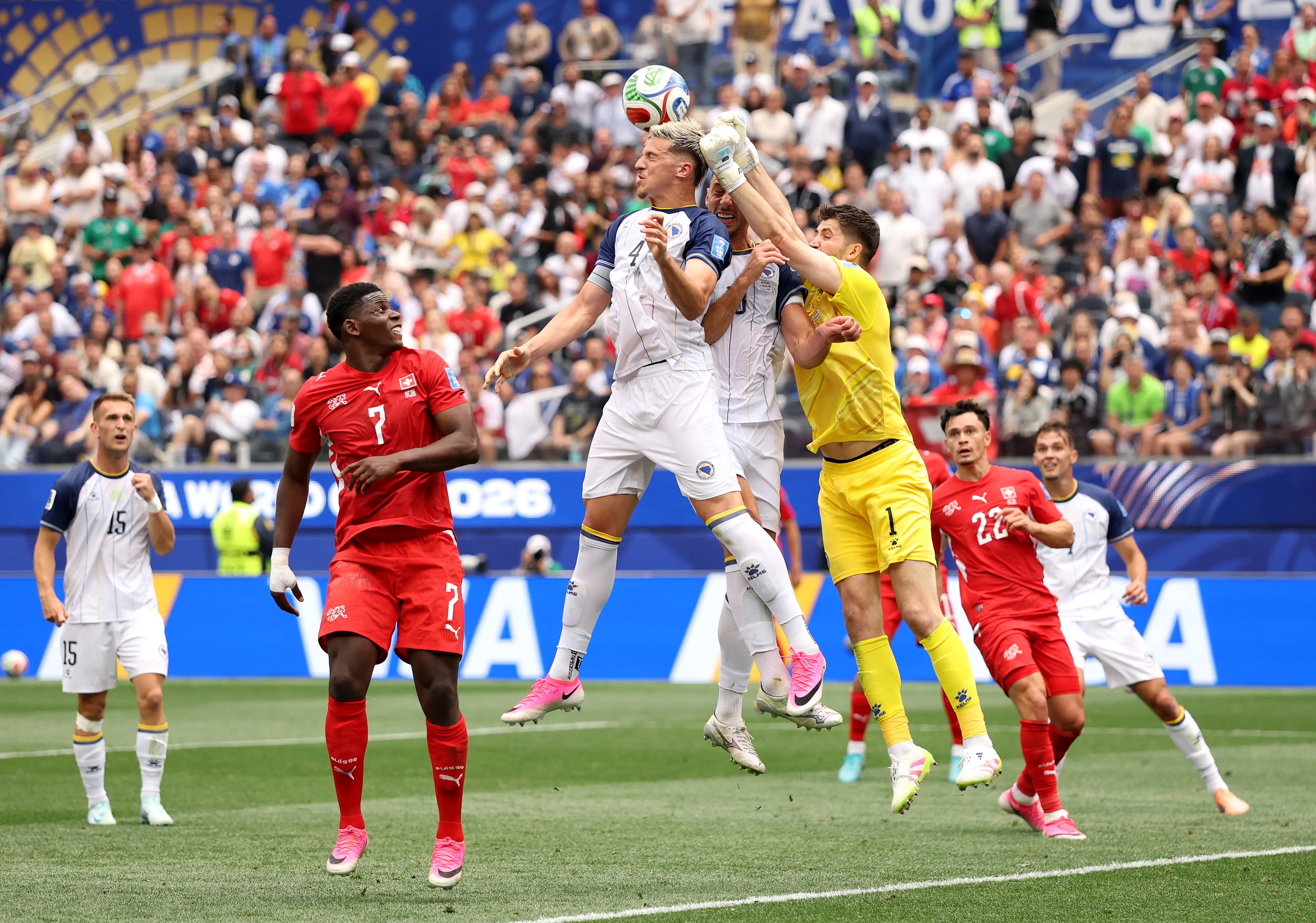 INGLEWOOD, CALIFORNIA – JUNE 18: Tarik Muharemovic #4 and Nikola Vasilj #1 of Bosnia and Herzegovina defend an attempt during the FIFA World Cup 2026 Group B match between Switzerland and Bosnia and Herzegovina at Los Angeles Stadium on June 18, 2026 in Inglewood, California. (Photo by Stu Forster/Getty Images)