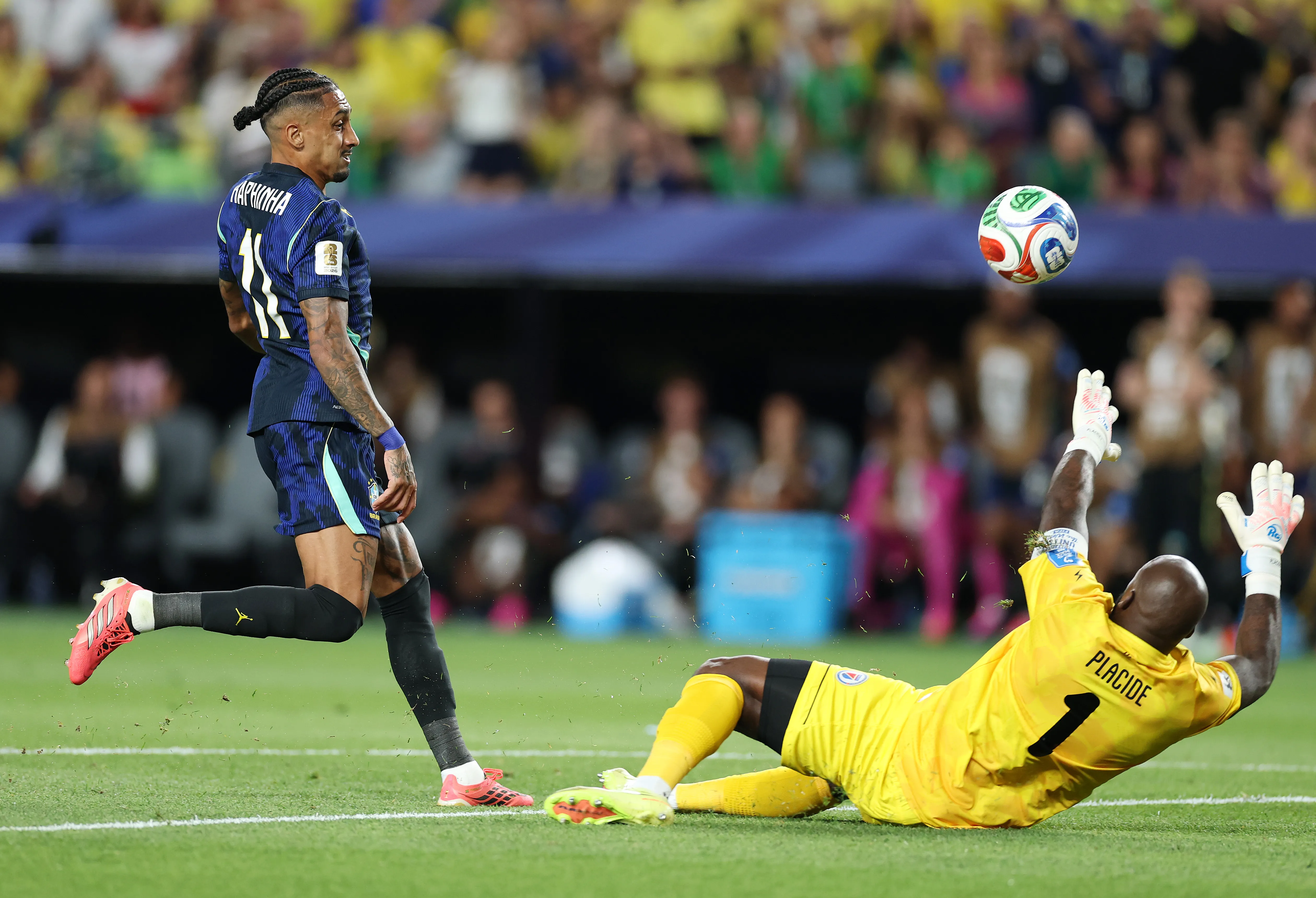 PHILADELPHIA, PENNSYLVANIA – JUNE 19:  Raphinha #11 of Brazil shoots against Johnny Placide #1 of Haiti during the FIFA World Cup 2026 Group C match between Brazil and Haiti at Philadelphia Stadium on June 19, 2026 in Philadelphia, Pennsylvania. (Photo by Al Bello/Getty Images)
