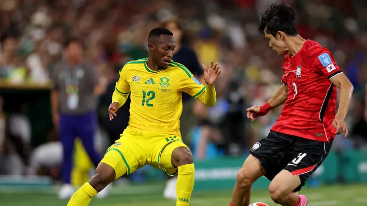 GUADALUPE, MEXICO - JUNE 24: Thapelo Maseko #12 of South Africa competes for the ball against Gi-Hyuk Lee #3 of Korea Republic during the FIFA World Cup 2026 Group A match between South Africa and Korea Republic at Monterrey Stadium on June 24, 2026 in Guadalupe, Mexico. (Photo by Carl Recine/Getty Images)